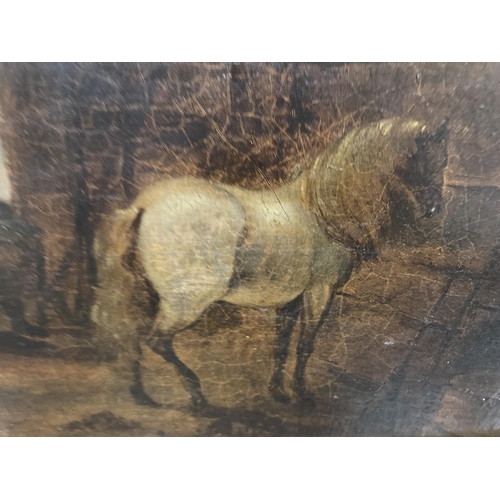 89 - A GILT FRAMED OIL ON BOARD OF A HORSE IN A STABLE