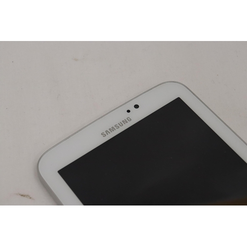 324 - A SAMSUNG TABLET WITH CHARGER, VENDOR STATES IN WORKING ORDER, NO WARRANTY GIVEN, 11CM X 19CM