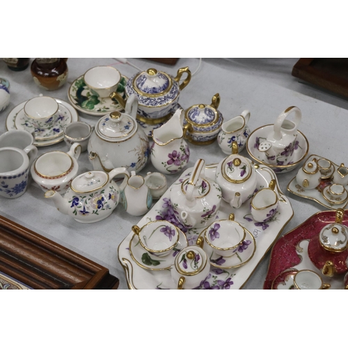 358 - A LARGE COLLECTION OF MINIATURE CHINA AND POTTERY TO INCLUDE LIMOGES AND HAMMERSLEY TEASETS ON TRAYS... 