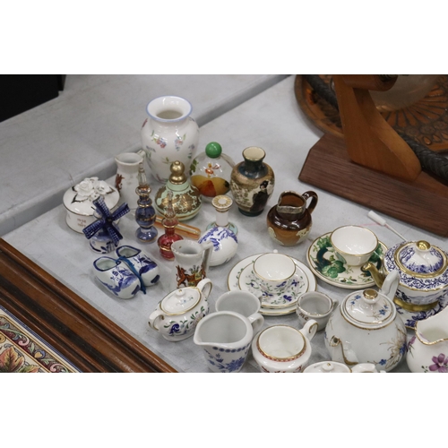 358 - A LARGE COLLECTION OF MINIATURE CHINA AND POTTERY TO INCLUDE LIMOGES AND HAMMERSLEY TEASETS ON TRAYS... 