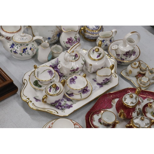 358 - A LARGE COLLECTION OF MINIATURE CHINA AND POTTERY TO INCLUDE LIMOGES AND HAMMERSLEY TEASETS ON TRAYS... 