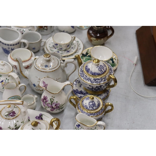 358 - A LARGE COLLECTION OF MINIATURE CHINA AND POTTERY TO INCLUDE LIMOGES AND HAMMERSLEY TEASETS ON TRAYS... 