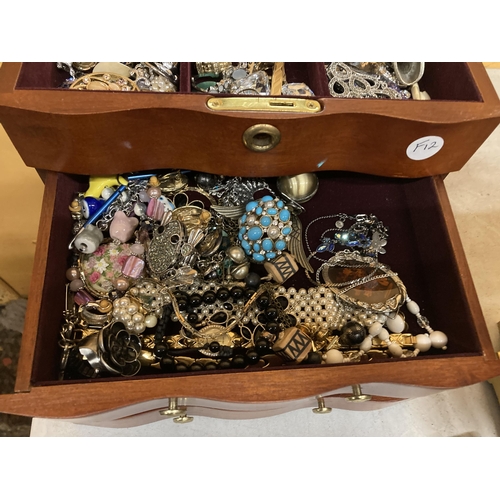 51 - A THREE DRAWER JEWELLERY CHEST WITH HINGED TOP, MIRROR AND COSTUME JEWELLERY CONTENTS