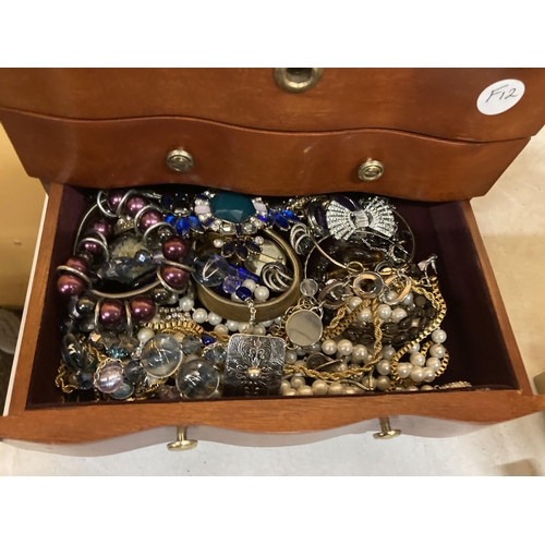 51 - A THREE DRAWER JEWELLERY CHEST WITH HINGED TOP, MIRROR AND COSTUME JEWELLERY CONTENTS