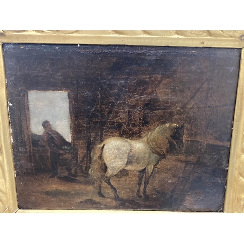 89 - A GILT FRAMED OIL ON BOARD OF A HORSE IN A STABLE