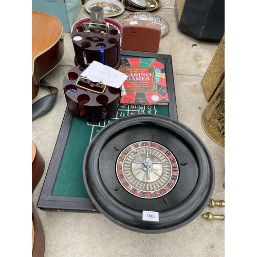 1808 - A ROULETTE GAMES SET TO INCLUDE A TABLE, WHEEL AND CHIPS ETC