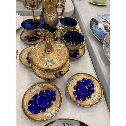 335 - A COLLECTION OF BOHEMIAN BLUE GLASSWARE WITH GILT AND FLORAL PATTERN TO INCLUDE A SMALL COFFEE POT, ... 