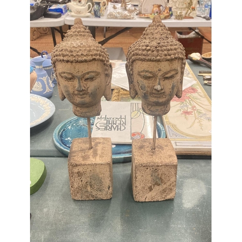 110 - A PAIR OF STONE BUDDAHS HEADS ON PLINTHS, HEIGHT 30CM