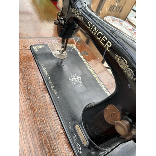 1694 - A VINTAGE SINGER SEWING MACHINE WITH OAK TABLE AND TREADLE BASE