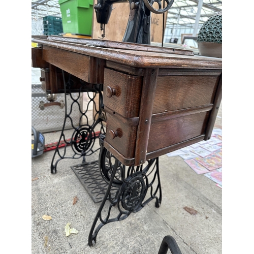 1694 - A VINTAGE SINGER SEWING MACHINE WITH OAK TABLE AND TREADLE BASE