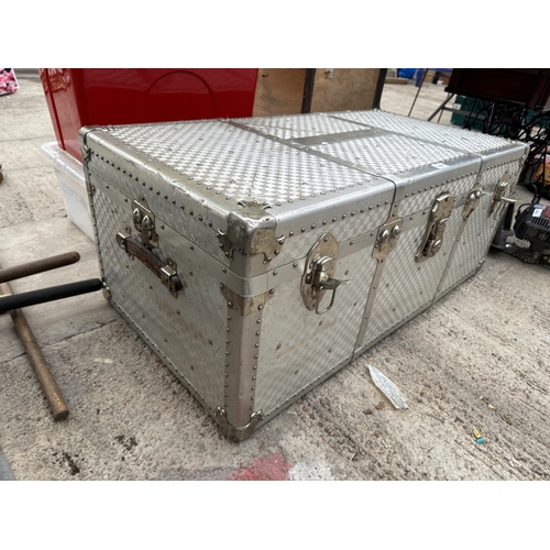 1696 - A LARGE ALUMINIUM COVERED TRAVEL TRUNK