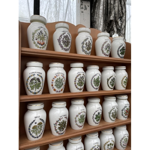 1599 - A WOODEN SPICE RACK WITH LOWER DRAWERS AND 23 GLORIA CONCEPTS THE FRANKLIN MINT LIDDED SPICE JARS