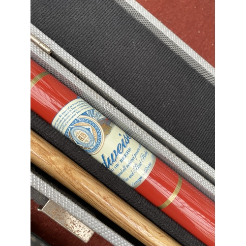 1601 - TWO CASED SNOOKER CUES TO INCLUDE A BCE CUSTOM CUE WITH BUDWIESER DESIGN ETC