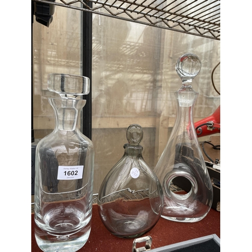 1602 - THREE VARIOUS GLASS DECANTERS