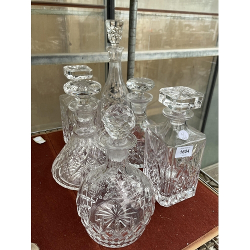 1604 - SIX ASSORTED CUT GLASS DECANTERS WITH STOPPERS