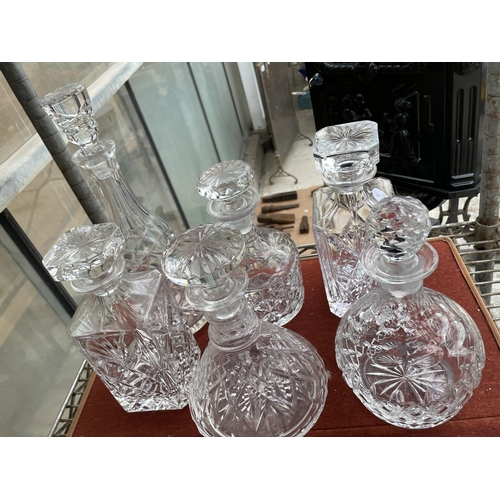 1604 - SIX ASSORTED CUT GLASS DECANTERS WITH STOPPERS