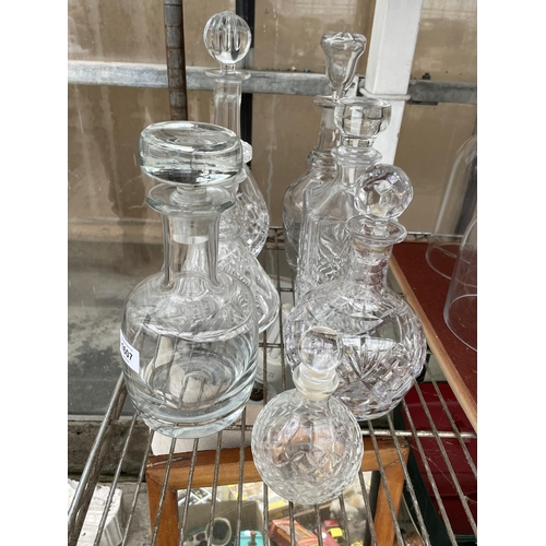 1607 - SIX VARIOUS CUT GLASS DECANTERS AND A FURTHER GLASS DECANTER WITH STOPPERS