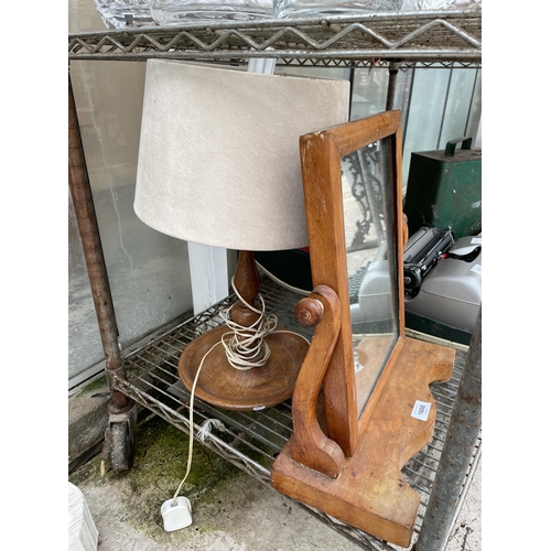 1608 - AN OAK SWING FRAME DRESSING TABLE MIRROR AND A DECORATIVE OAK TABLE LAMP