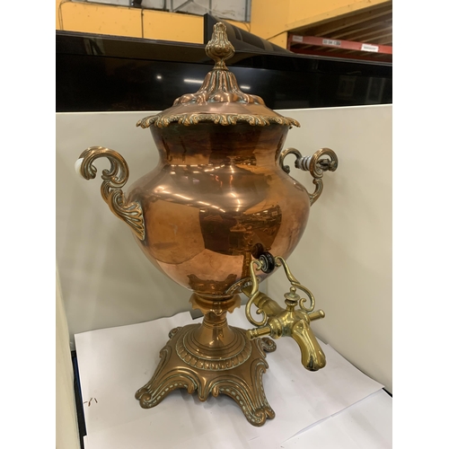 44 - A VINTAGE DECORATIVE COPPER AND BRASS SAMOVAR WITH WHITE HANDLES (ONE A/F)