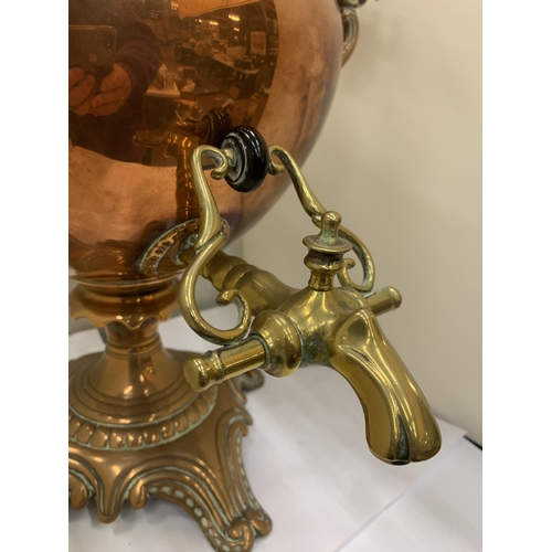 44 - A VINTAGE DECORATIVE COPPER AND BRASS SAMOVAR WITH WHITE HANDLES (ONE A/F)