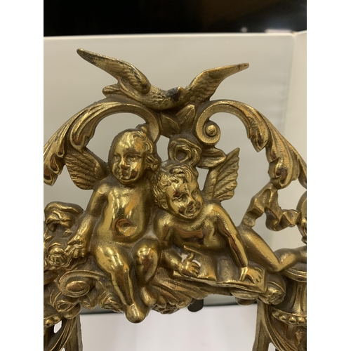 17 - A DECORATIVE HEAVY BRASS FRAME WITH CHERUBS