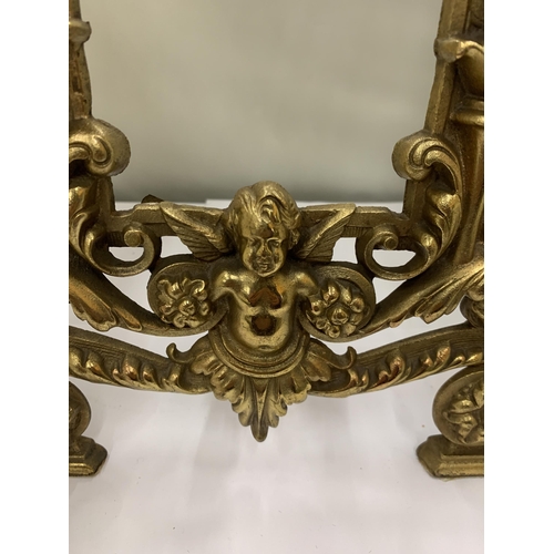 17 - A DECORATIVE HEAVY BRASS FRAME WITH CHERUBS