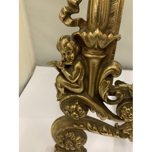 17 - A DECORATIVE HEAVY BRASS FRAME WITH CHERUBS