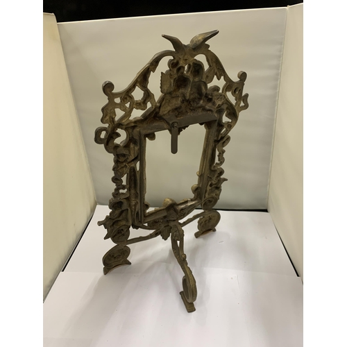 17 - A DECORATIVE HEAVY BRASS FRAME WITH CHERUBS