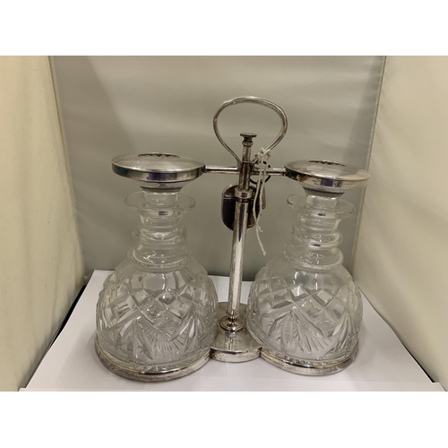 3 - A WHITE METAL TANTALUS WITH TWO CUT GLASS DECANTERS WITH PADLOCK AND KEY