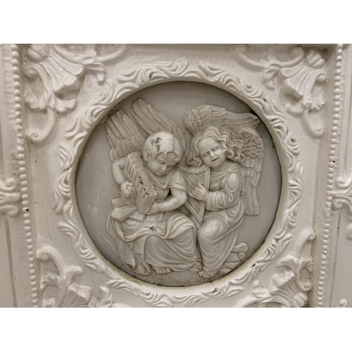 34 - TWO ORNATELY FRAMED SCULPTURES OF ANGELS