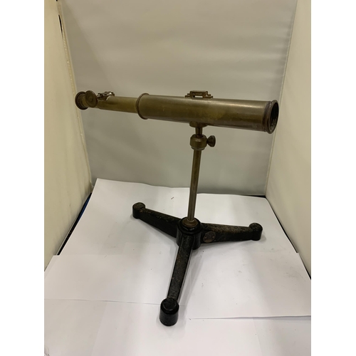 55 - A VINTAGE BRASS TELESCOPE ON A CAST TRIPOD STAND