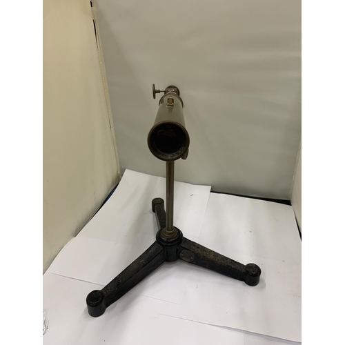 55 - A VINTAGE BRASS TELESCOPE ON A CAST TRIPOD STAND