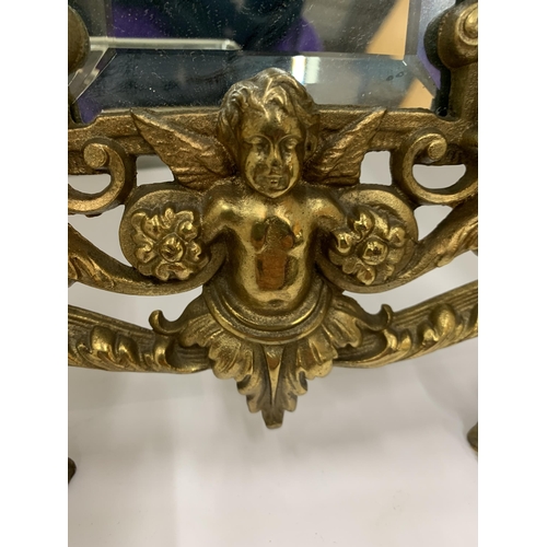 7 - A MIRROR WITH A HEAVY BRASS DECORATIVE FRAME HEIGHT 36CM