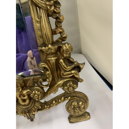 7 - A MIRROR WITH A HEAVY BRASS DECORATIVE FRAME HEIGHT 36CM