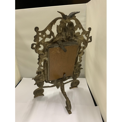 7 - A MIRROR WITH A HEAVY BRASS DECORATIVE FRAME HEIGHT 36CM