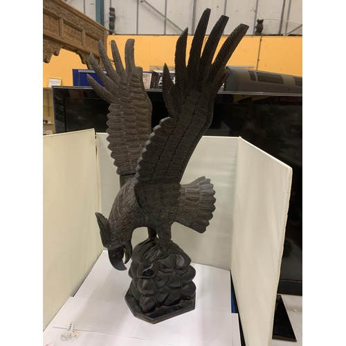 85 - A VINTAGE HANDCARVED WOODEN EAGLE WITH REMOVEABLE WINGS HEIGHT 60CM