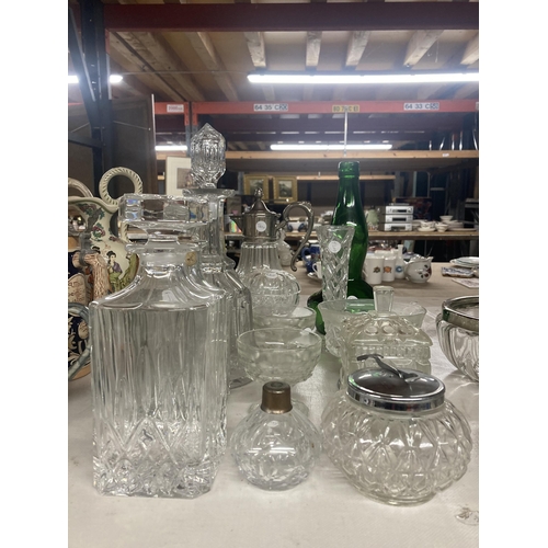 1112 - A QUANTITY OF CUT GLASS TO INCLUDE DECANTERS, JARS, SILVER PLATED TOP CARAFE ETC