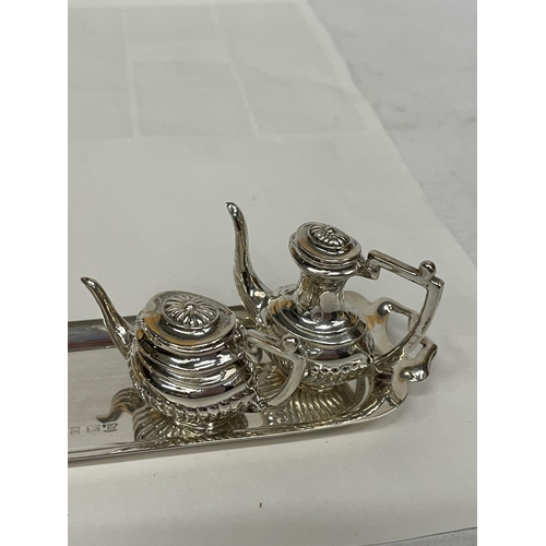 77 - A MINATURE HALLMARKED BIRMINGHAM SILVER TEASET ON A TRAY