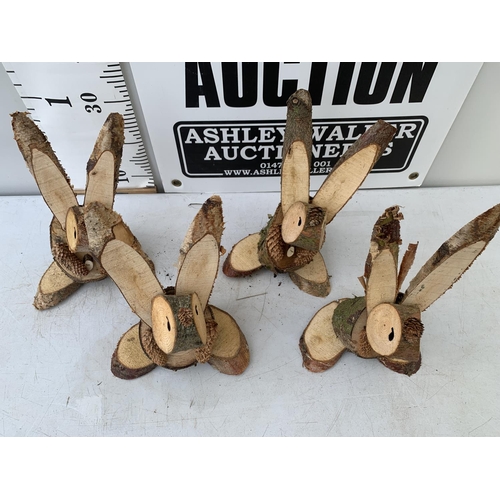 158 - FOUR RABBIT FIGURES MADE FROM LOGS NO VAT TO BE SOLD FOR THE FOUR