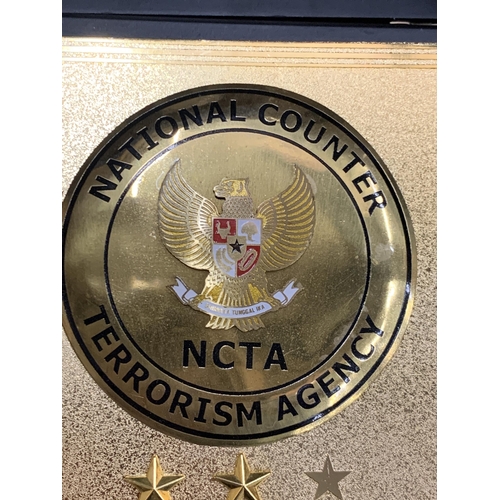 31 - AN AUTHENTIC BOXED COMMENDATION PLAQUE, AWARDED TO DR BOY RAFLIAMAR BY THE NATIONAL COUNTER TERRORIS... 