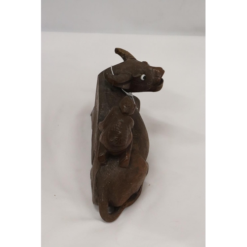 202 - AN ORIENTAL WOODEN CARVED WATER BUFFALO WITH CHILD RIDER, A/F TO LEG, HEIGHT 12CM, LENGTH 22CM