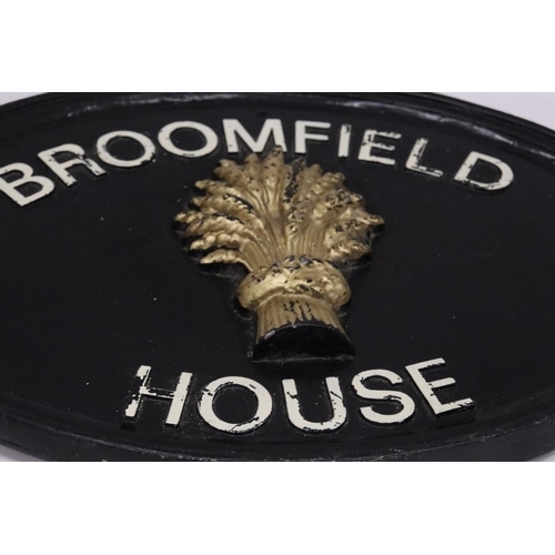 219 - A CAST IRON HOUSE SIGN, 39CM X 28CM