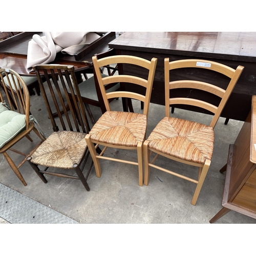 3276 - TWO BEECH DINING CHAIRS WITH RUSH SEATS AND AN OAK NURSING CHAIR WITH RUSH SEAT