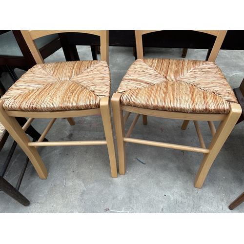 3276 - TWO BEECH DINING CHAIRS WITH RUSH SEATS AND AN OAK NURSING CHAIR WITH RUSH SEAT