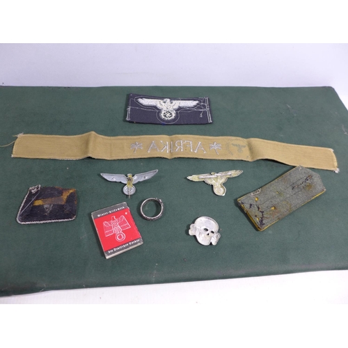 327 - A COLLECTION OF NAZI GERMANY WORLD WAR II BADGES TO INCLUDE AN AFRIKA CORPS TALLY, MINIATURE ADOLF H... 