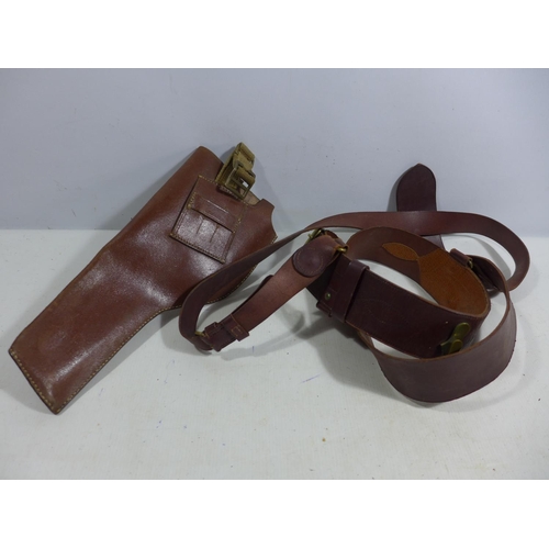 335 - A MILITARY BROWN LEATHER GUN HOLSTER AND LEATHER SAM BROWNE BELT