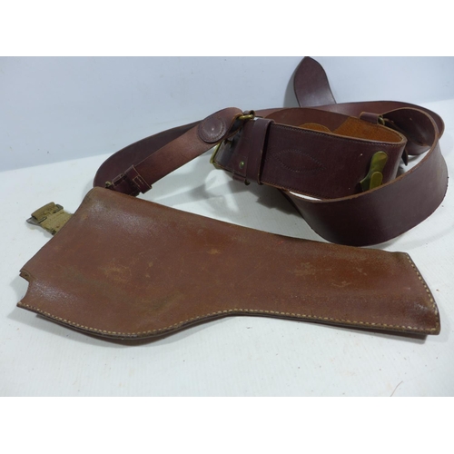 335 - A MILITARY BROWN LEATHER GUN HOLSTER AND LEATHER SAM BROWNE BELT