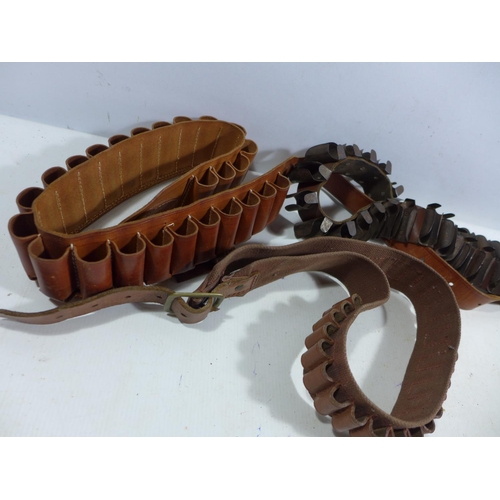 338 - THREE CARTRIDGE HOLDER BELTS, SHOTGUN BARREL HEAT HANDLE AND A LEATHER POWDER FLASK