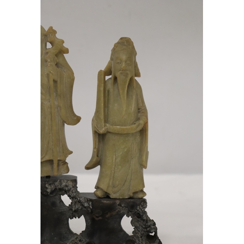 109 - AN ORIENTAL CARVING OF THREE ELDERS ON A PLINTH, HEIGHT 21CM, WIDTH 22CM