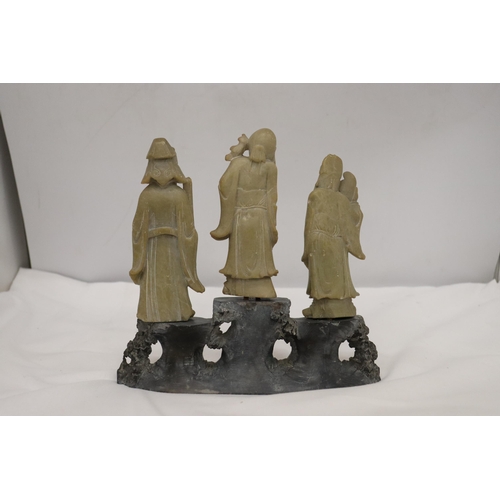 109 - AN ORIENTAL CARVING OF THREE ELDERS ON A PLINTH, HEIGHT 21CM, WIDTH 22CM